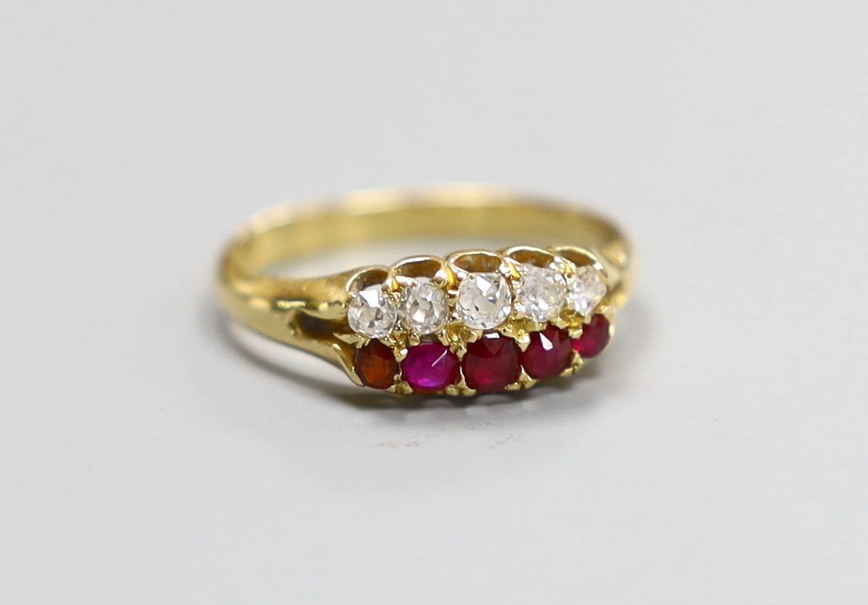 A late Victorian 18ct gold, graduated five stone ruby and five stone diamond set twin row ring, size O, gross 3 grams.